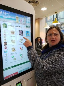 Stacy ordering from a McDonalds kiosk in London